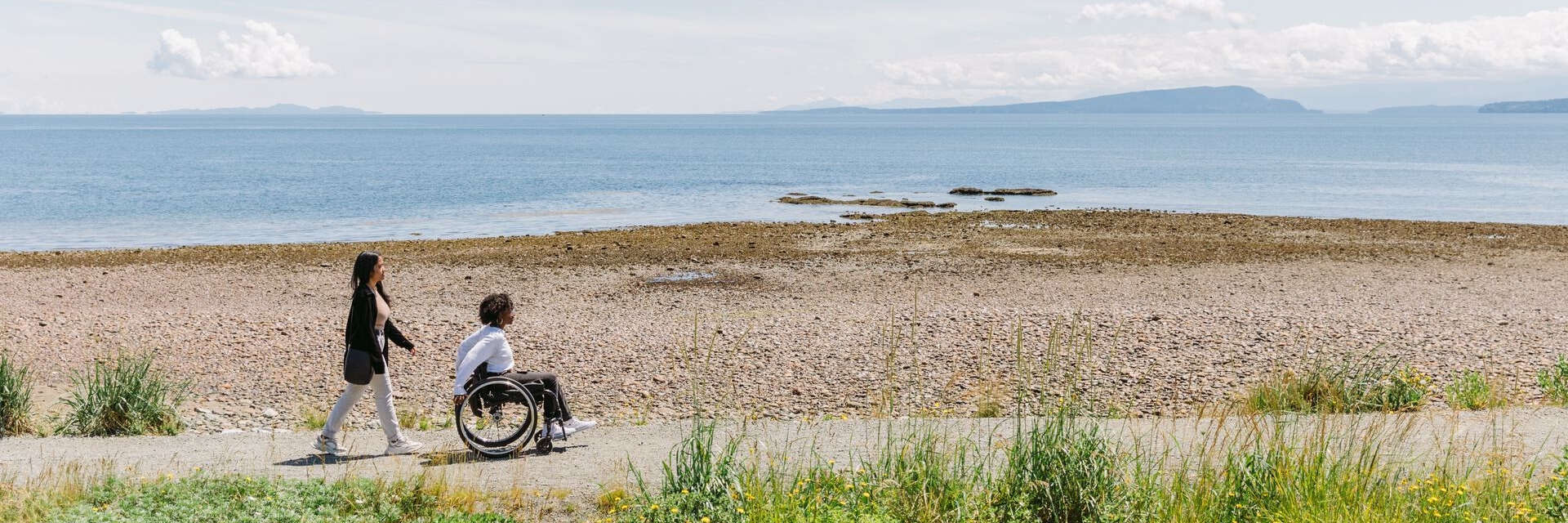 two people enjoying the seaside accessible trail at Point Holmes near Comox